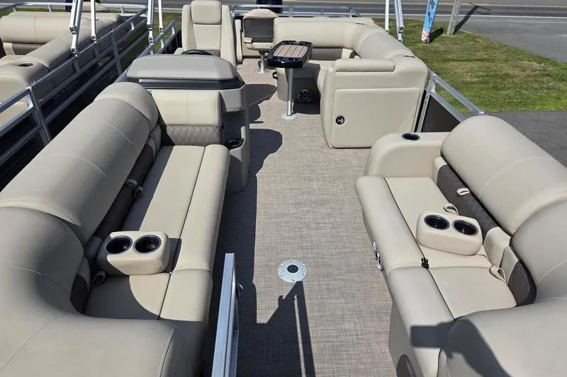 Slide: The Image of 2025 Sun Tracker SF 22 DLX pontoon boat interior with beige seating and cup holders. - 5