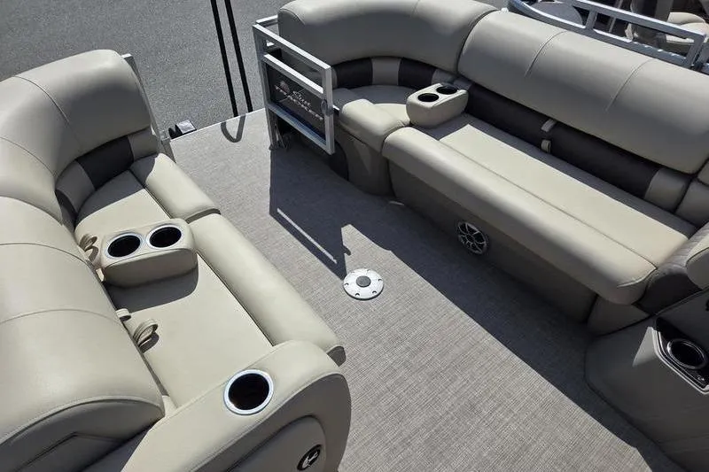Slide: The Image of 2025 Sun Tracker SF 22 DLX pontoon boat interior with beige seating and cup holders. - 6