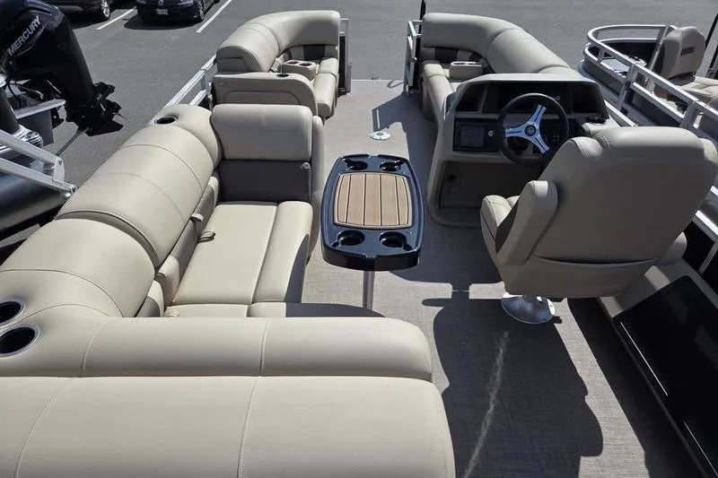 Slide: The Image of 2025 Sun Tracker SF 22 DLX pontoon boat interior with beige seating and steering console. - 7