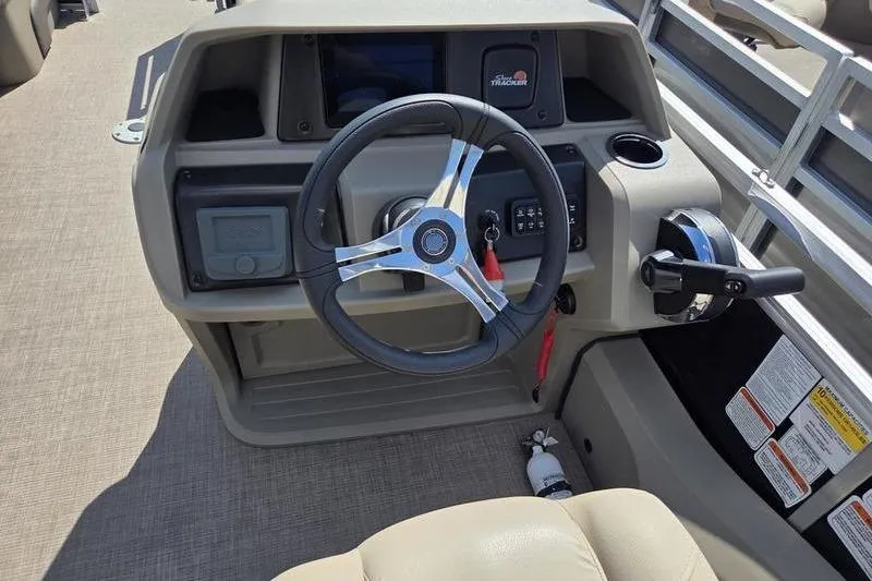 Slide: The Image of Steering console of 2025 Sun Tracker SF 22 DLX pontoon boat, featuring modern controls. - 8