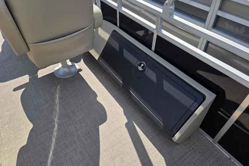 Slide: The Image of 2025 Sun Tracker SF 22 DLX boat interior with seating and storage compartment. - 9