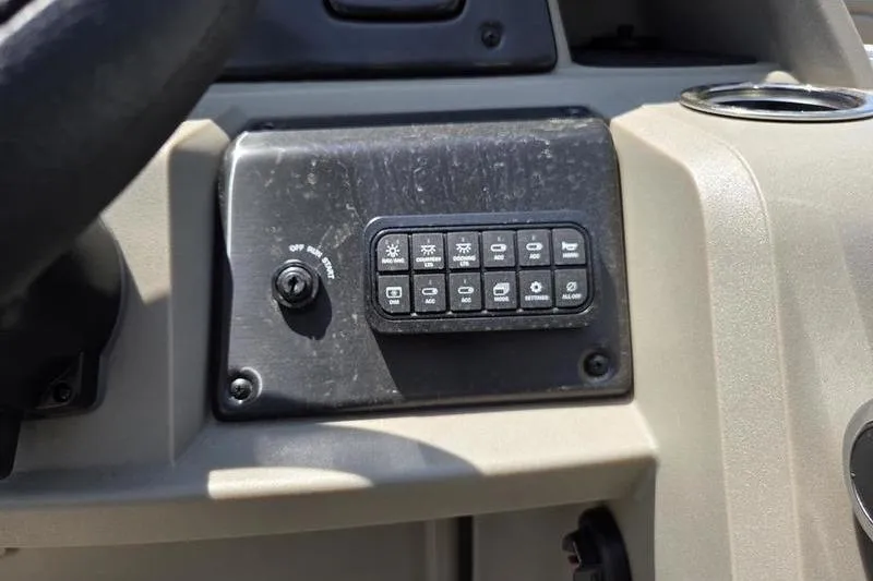 Slide: The Image of Control panel of 2025 Sun Tracker PB 22 RF boat with various switches and buttons. - 10