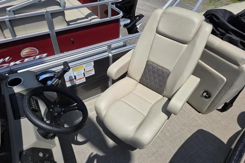 Slide: The Image of 2025 Sun Tracker PB 22 RF boat interior with beige captain's chair and steering wheel. - 12