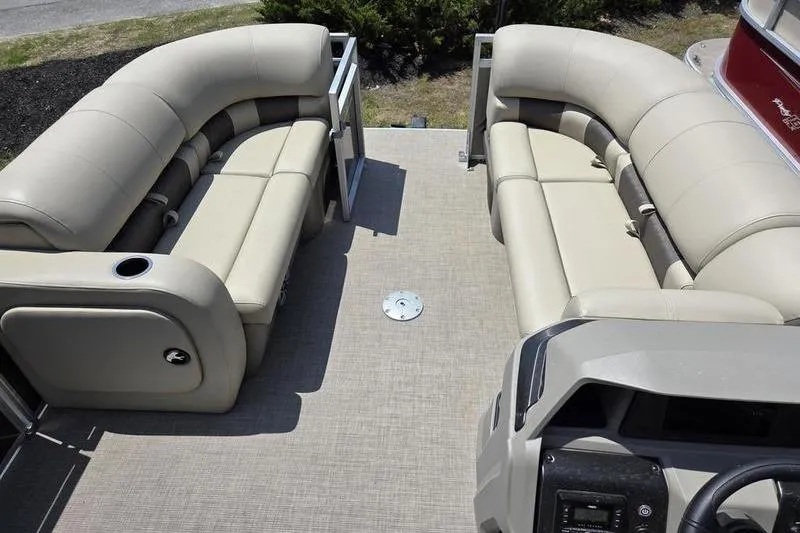 Slide: The Image of 2025 Sun Tracker PB 22 RF pontoon boat interior with beige seating and steering console. - 13
