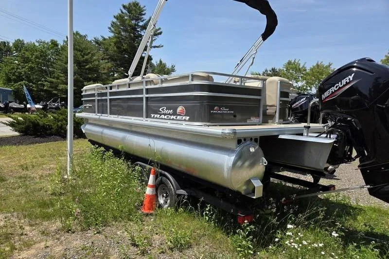 Slide: The Image of 2025 Sun Tracker PB 22 RF pontoon boat on trailer, parked outdoors. - 5
