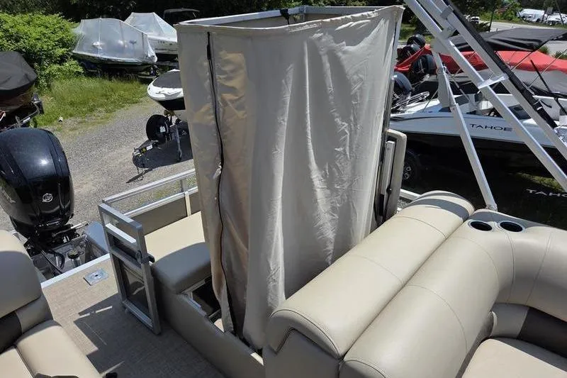 Slide: The Image of 2025 Sun Tracker PB 22 RF pontoon boat with privacy curtain and seating area. - 7