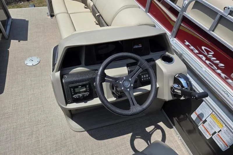 Slide: The Image of 2025 Sun Tracker PB 22 RF boat dashboard with steering wheel and controls. - 9
