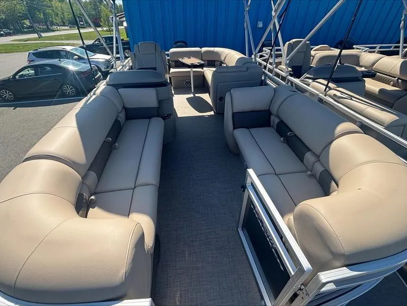 Slide: The Image of 2024 Sun Tracker PB 20 DLX pontoon boat with spacious beige seating and modern design. - 4
