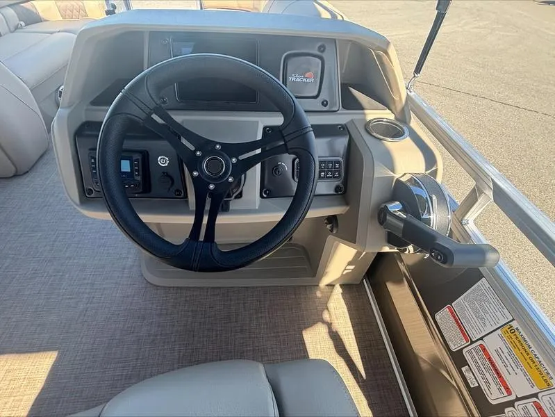 Slide: The Image of 2024 Sun Tracker PB 20 DLX boat steering console with controls and dashboard. - 5