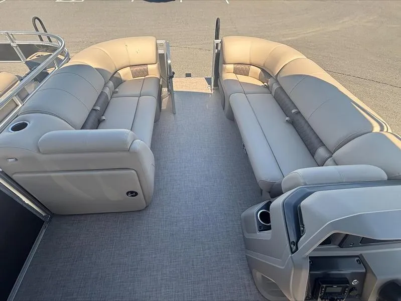 Slide: The Image of 2024 Sun Tracker PB 20 DLX pontoon boat interior with beige seating and gray flooring. - 6