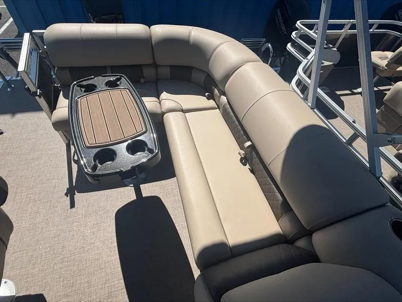 Slide: The Image of 2024 Sun Tracker PB 20 DLX pontoon boat with beige seating and table. - 9