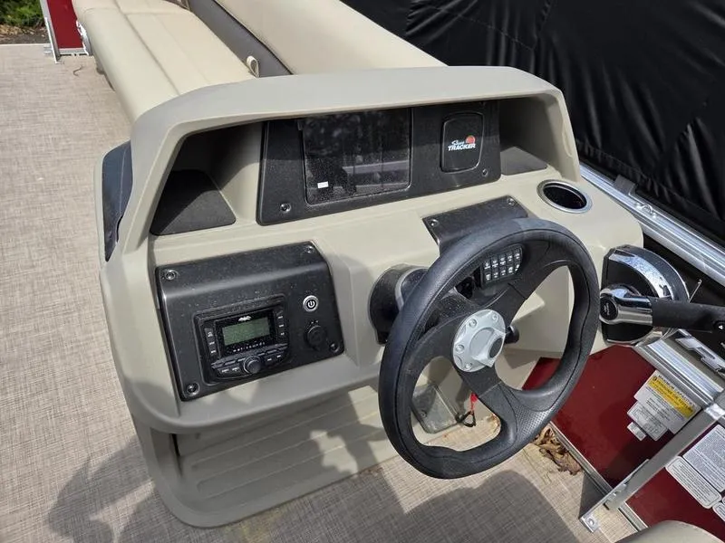Slide: The Image of Steering console of 2025 Sun Tracker PB 18 DLX pontoon boat with controls and dashboard. - 3