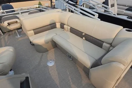 Slide: The Image of 2025 Sun Tracker FB 22 DLX pontoon boat with beige seating and spacious deck layout. - 13