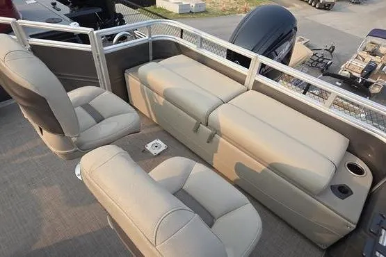 Slide: The Image of 2025 Sun Tracker FB 22 DLX pontoon boat interior with beige seating and cup holders. - 15