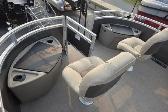 Slide: The Image of 2025 Sun Tracker FB 22 DLX pontoon boat interior with beige seating and storage compartments. - 19
