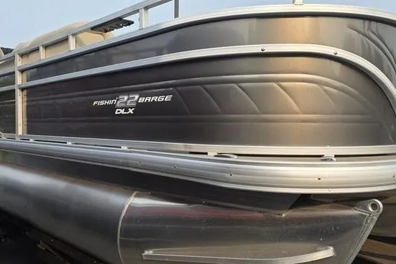 Slide: The Image of 2025 Sun Tracker FB 22 DLX pontoon boat with sleek metallic finish. - 4