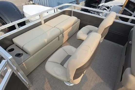 Slide: The Image of 2025 Sun Tracker FB 22 DLX pontoon boat interior with beige seating and cup holders. - 9