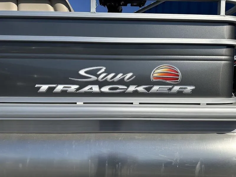 Slide: The Image of 2025 Sun Tracker FB 20 DLX logo on a sleek boat exterior. - 2