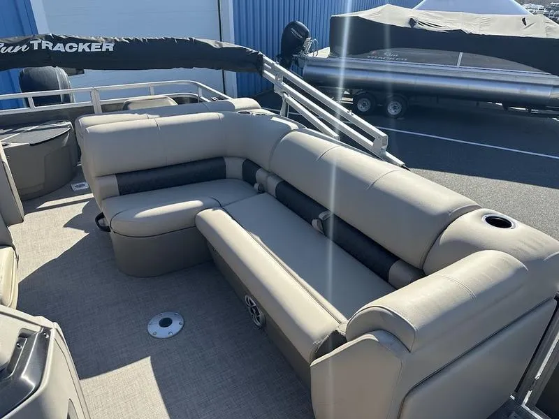 Slide: The Image of 2025 Sun Tracker FB 20 DLX pontoon boat with beige seating and spacious deck. - 6