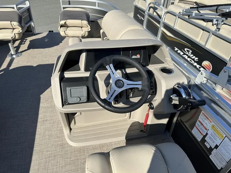 Slide: The Image of 2025 Sun Tracker FB 20 DLX boat interior with steering wheel and seating. - 7