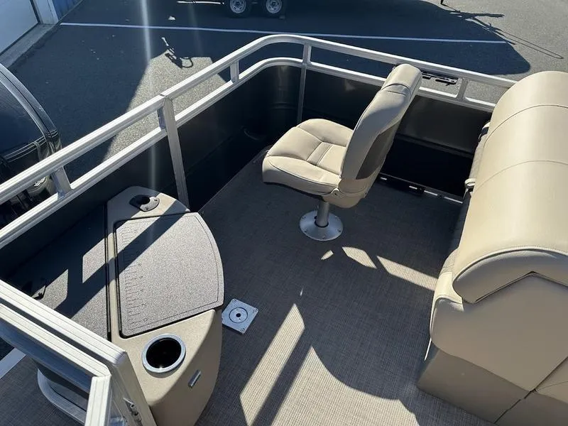 Slide: The Image of 2025 Sun Tracker FB 20 DLX pontoon boat interior with beige seating and table. - 9