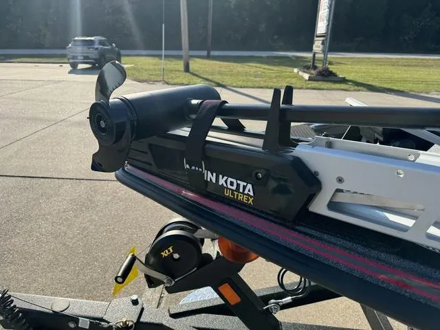 Slide: The Image of Phoenix 819 ZXL boat with Minn Kota Ultrex trolling motor, parked outdoors. - 14