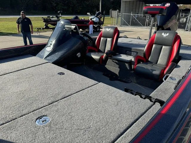 Slide: The Image of 2025 Phoenix 819 ZXL boat with red and black seats, parked outdoors. - 17