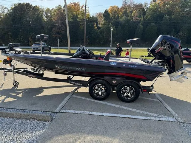 Slide: The Image of 2025 Phoenix 819 ZXL boat on trailer, parked outdoors, side view. - 21
