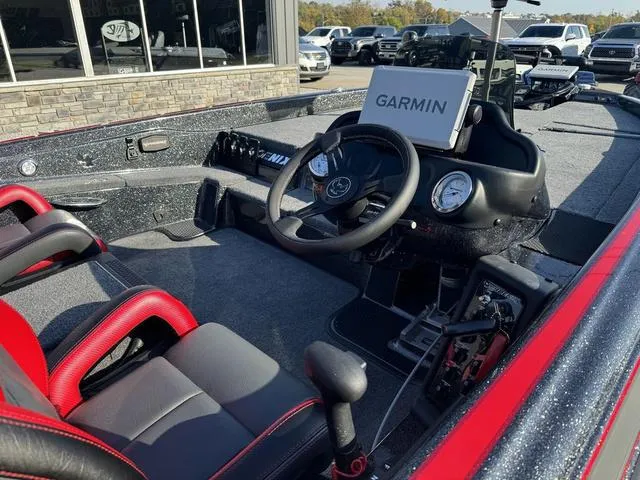 Slide: The Image of Phoenix 819 ZXL 2025 boat interior with Garmin navigation system and red-accented seats. - 6