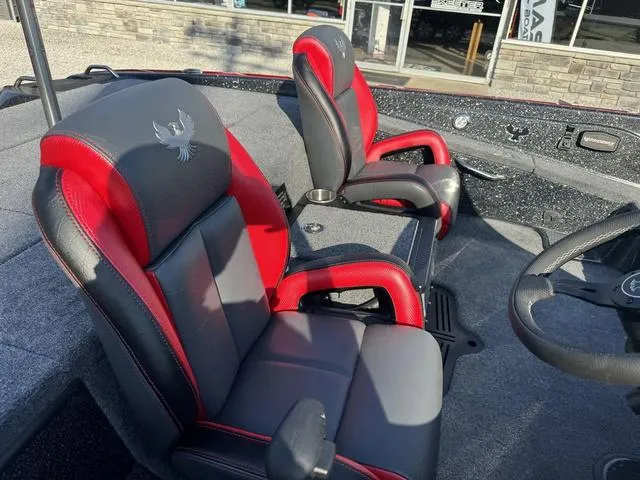 Slide: The Image of 2025 Phoenix 819 ZXL boat interior with red and black seats, steering wheel, and console. - 7