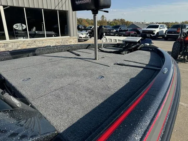 Slide: The Image of 2025 Phoenix 819 ZXL boat with spacious deck, parked outdoors. - 8