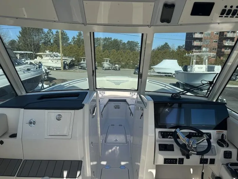Slide: The Image of 2025 Sailfish 316 DC boat cockpit with modern controls and navigation system. - 12