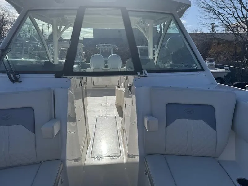 Slide: The Image of 2025 Sailfish 316 DC boat interior with seating and helm, showcasing modern design. - 15
