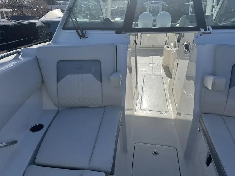 Slide: The Image of 2025 Sailfish 316 DC boat interior with white seating and open cockpit view. - 16