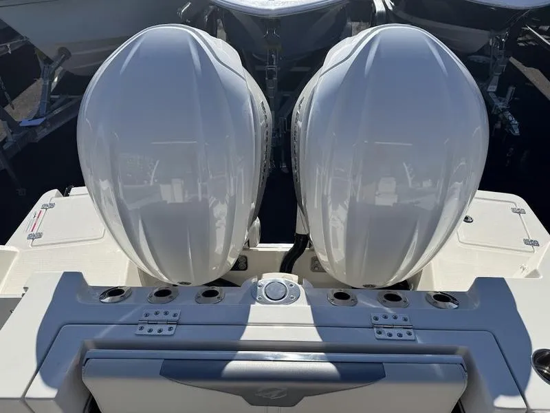 Slide: The Image of 2025 Sailfish 316 DC boat with dual outboard engines, rear view. - 17