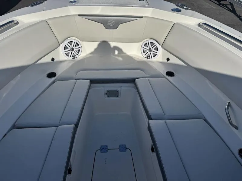 Slide: The Image of 2025 Sailfish 316 DC boat interior with cushioned seating and built-in speakers. - 18