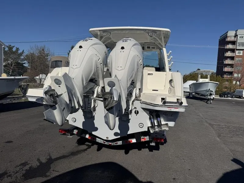 Slide: The Image of 2025 Sailfish 316 DC boat with dual outboard motors, parked on a trailer. - 20