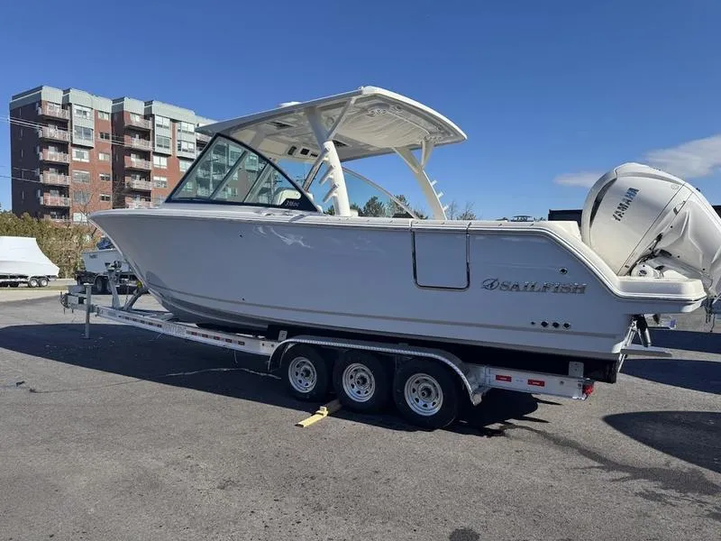 Slide: The Image of 2025 Sailfish 316 DC boat on trailer, parked outdoors near buildings. - 21