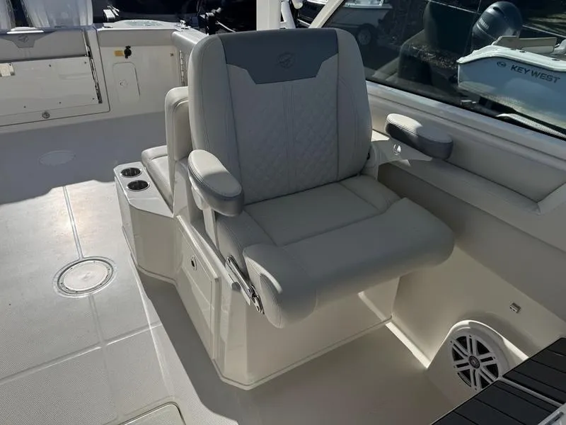 Slide: The Image of Luxury seating on 2025 Sailfish 316 DC boat, featuring plush upholstery and armrests. - 8