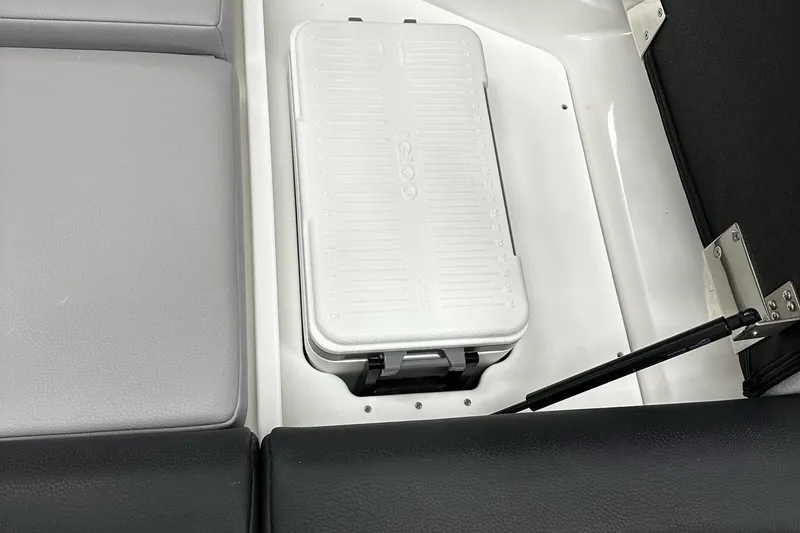 Slide: The Image of 2025 Cobalt CS23 Surf boat interior with storage compartment and cooler. - 10