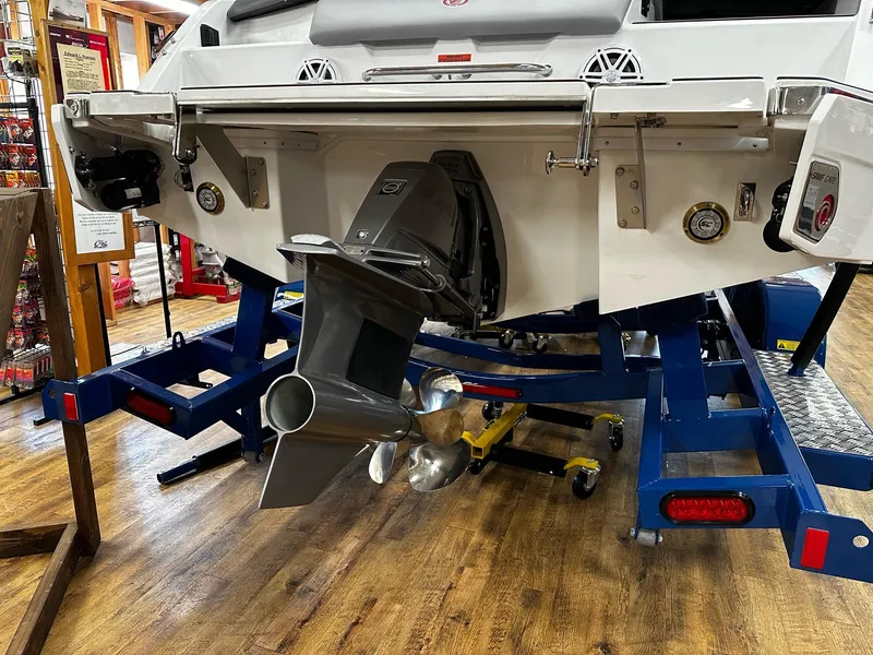 Slide: The Image of 2025 Cobalt CS23 Surf boat on trailer, showcasing propeller and stern details. - 4