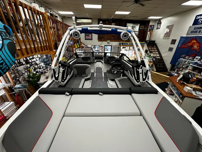 Slide: The Image of 2025 Cobalt CS23 Surf boat interior in showroom, featuring modern design and spacious seating. - 9
