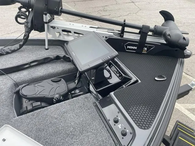 Slide: The Image of 2025 Phoenix 721 ZXL boat dashboard with Minn Kota trolling motor and control panel. - 10