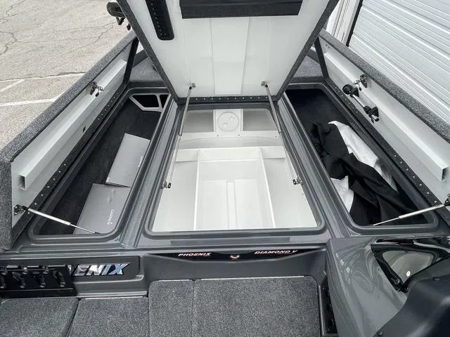 Slide: The Image of 2025 Phoenix 721 ZXL boat interior with open storage compartments. - 12