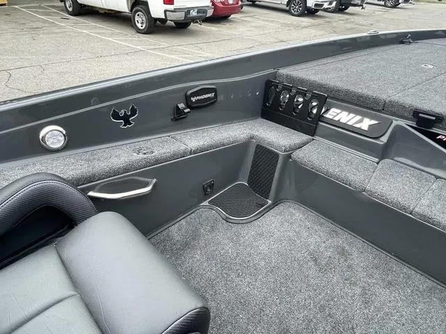Slide: The Image of 2025 Phoenix 721 ZXL boat interior with gray seating and control panel. - 13
