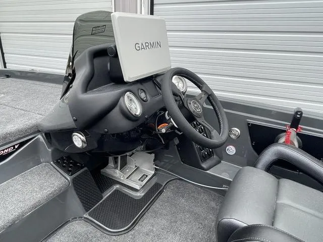 Slide: The Image of 2025 Phoenix 721 ZXL boat cockpit with Garmin navigation system and sleek steering wheel. - 14