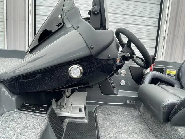 Slide: The Image of 2025 Phoenix 721 ZXL boat interior with steering wheel and dashboard controls. - 15