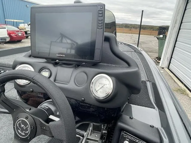 Slide: The Image of Phoenix 721 ZXL 2025 boat dashboard with Garmin display and steering wheel. - 17