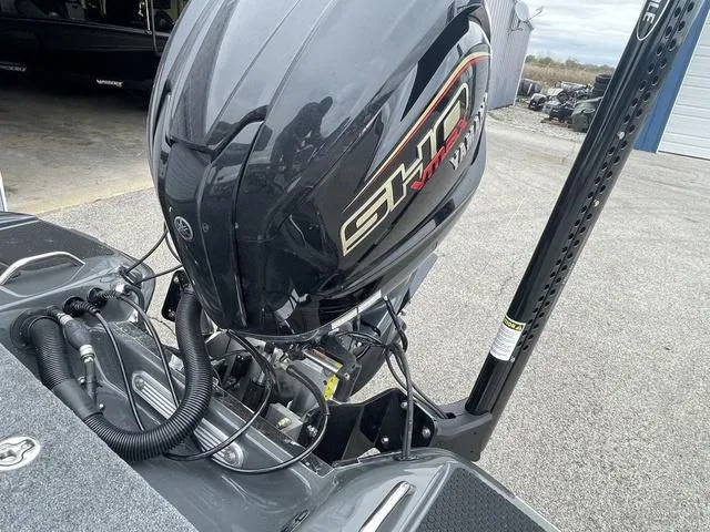 Slide: The Image of 2025 Phoenix 721 ZXL boat with powerful outboard motor in a parking area. - 21