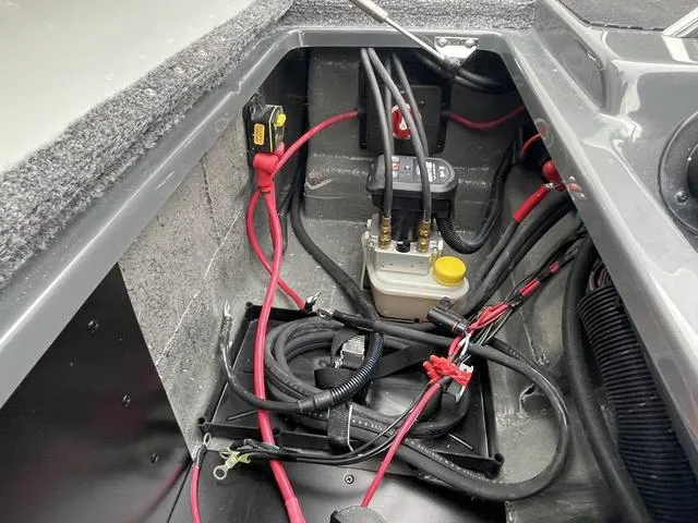 Slide: The Image of 2025 Phoenix 721 ZXL boat battery compartment with wiring and connections. - 23